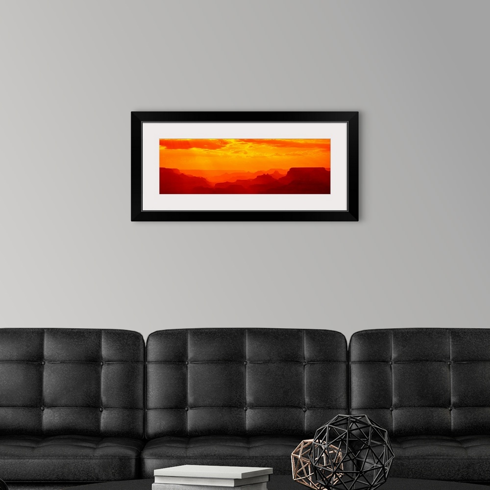 A modern room featuring Tonal panoramic photograph of canyon silhouettes at sunrise.