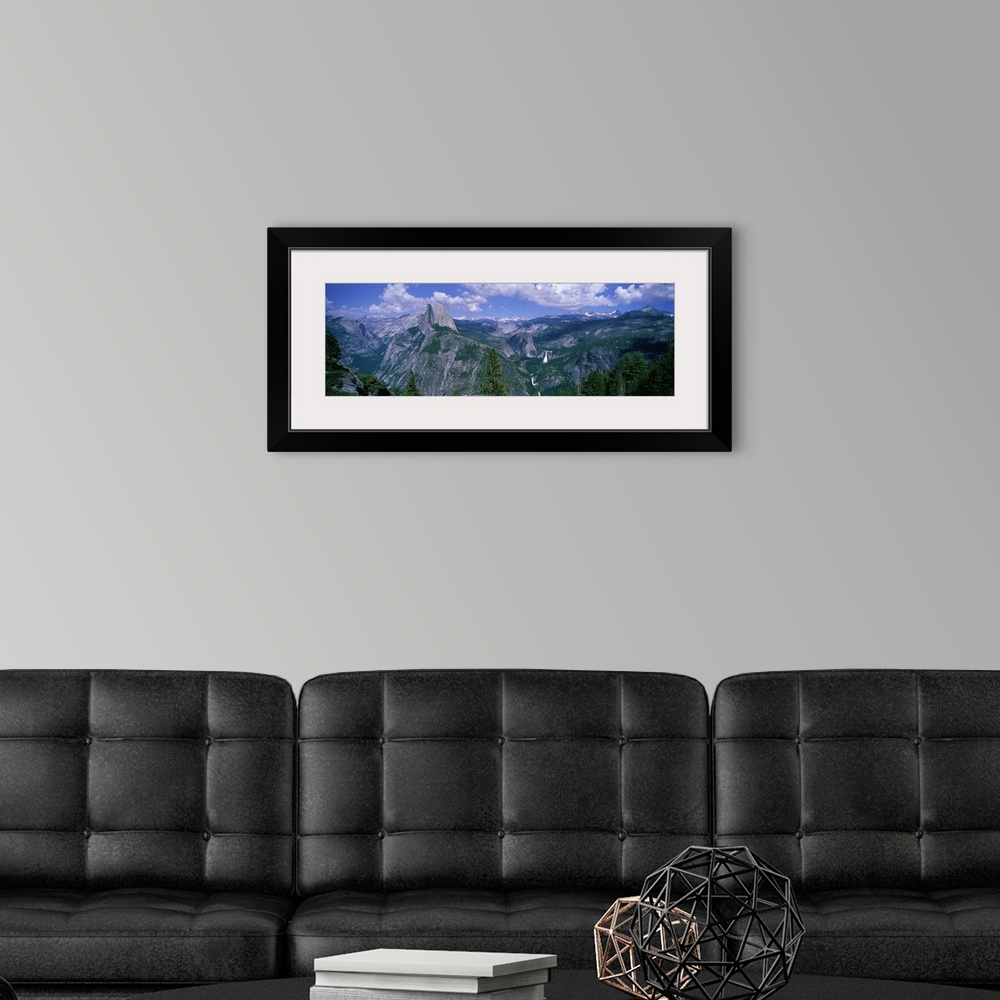 A modern room featuring Panoramic photograph taken from an aerial view overlooking a giant mountain range scattered with ...