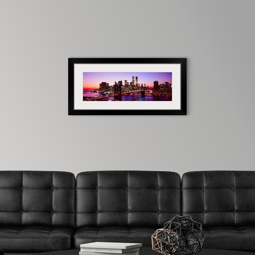 A modern room featuring Large artwork for a living room of office of the Brooklyn Bridge and Manhattan with lights shinin...