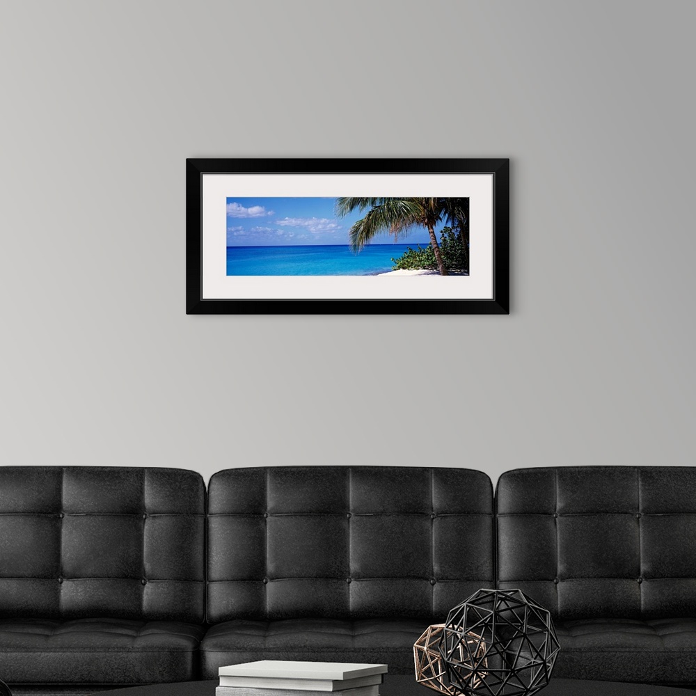 A modern room featuring Wall art for the home or office this panoramic photograph captures a still sea with minimal cloud...