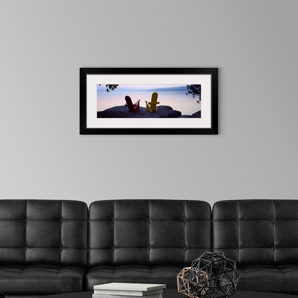 A modern room featuring Horizontal photograph on a big canvas of two adirondack chairs sitting at the edge of a rocky cli...