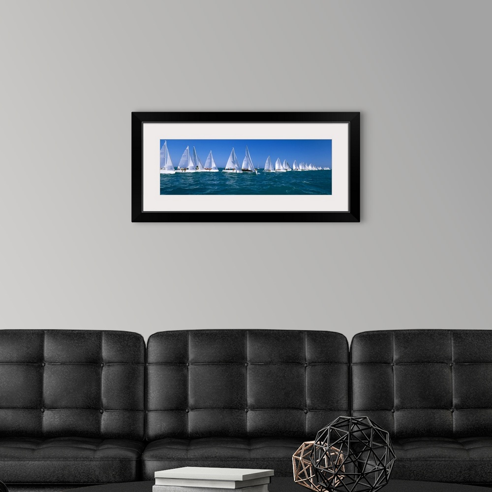 A modern room featuring Long and narrow photo print of sailboats lined up in the ocean for a race.