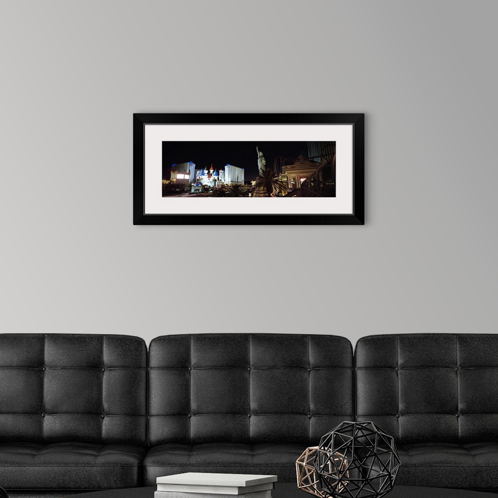 A modern room featuring Panoramic photograph of the Las Vegas strip at night, the Statue of Liberty and New York, New Yor...