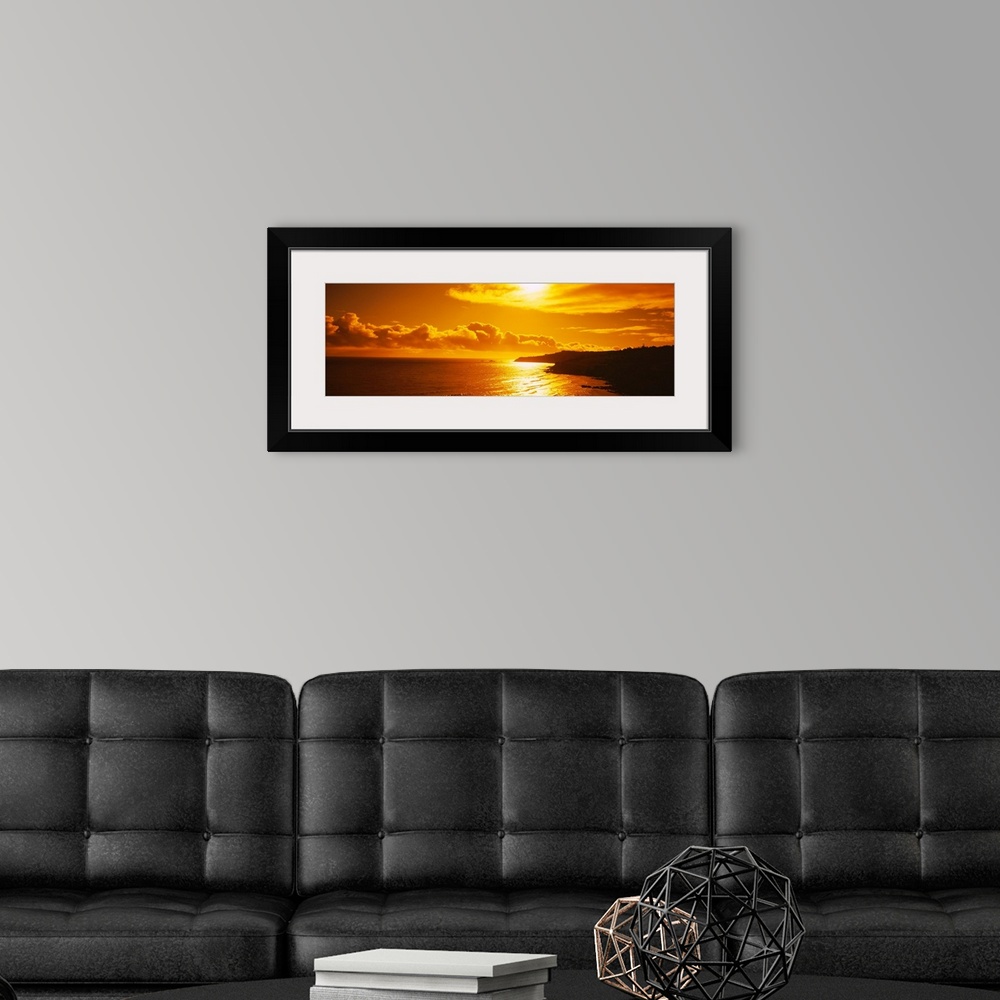 A modern room featuring This photograph is a panoramic seascape of the sun reflecting off the shallow beach water as it s...
