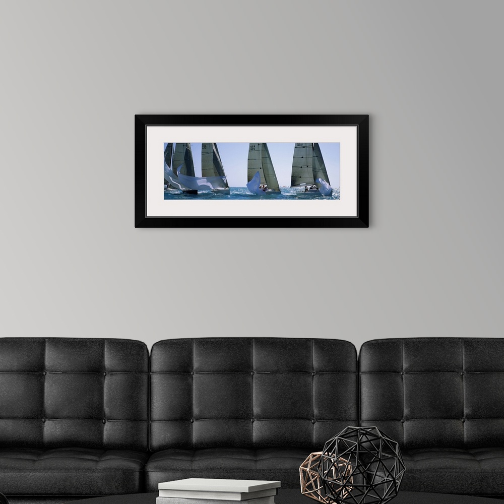 A modern room featuring Giant, wide angle photograph of five yachts racing on a sunny day, in the waters of Key West, Flo...