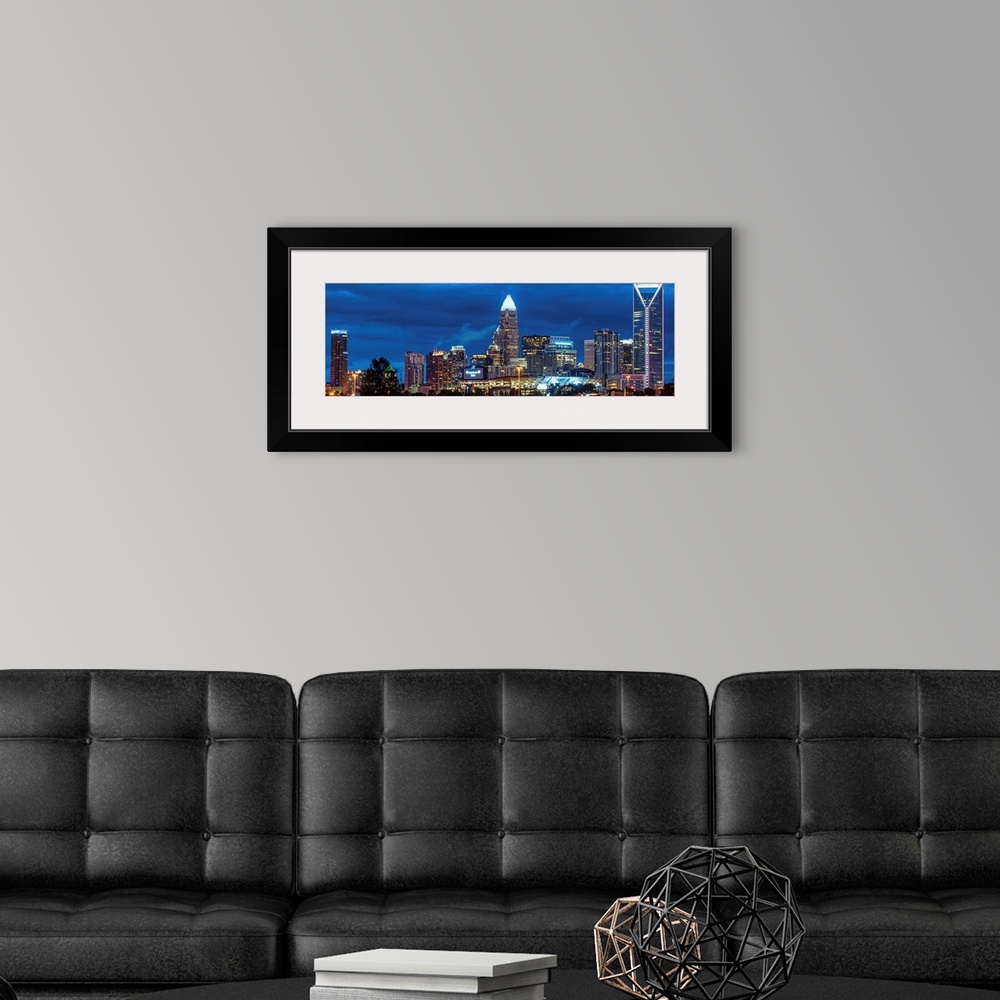 A modern room featuring Horizontal image of the city of Charlotte, North Carolina at night.
