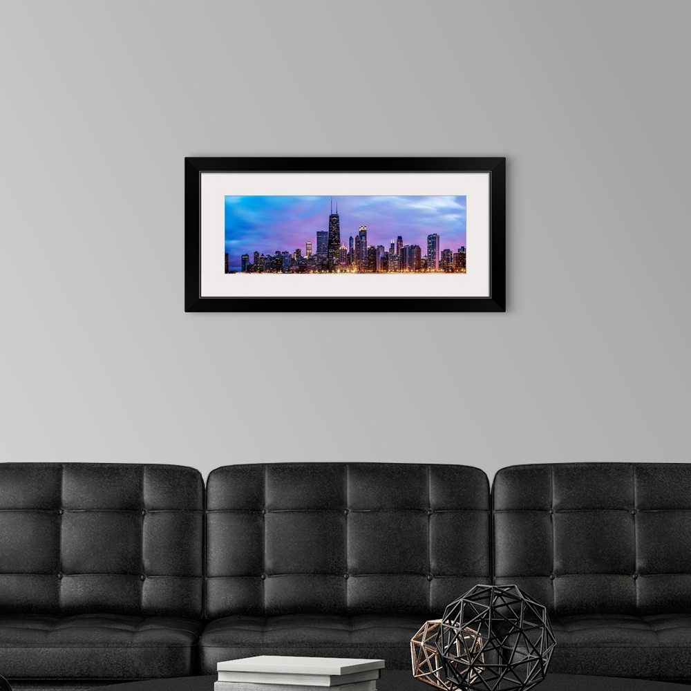 A modern room featuring Photo of Chicago skyline at night under cotton candy colored clouds.