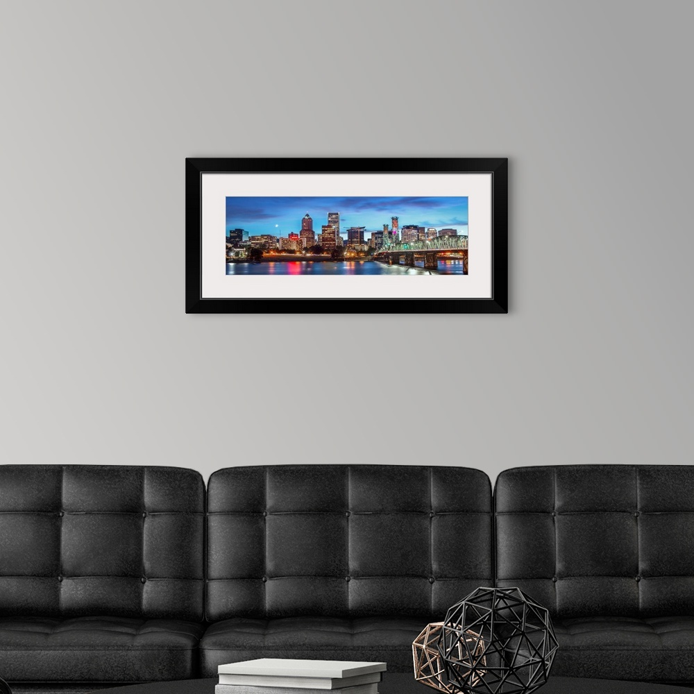 A modern room featuring Panoramic photograph of a saturated Portland, Oregon skyline at sunset reflecting onto the Willam...