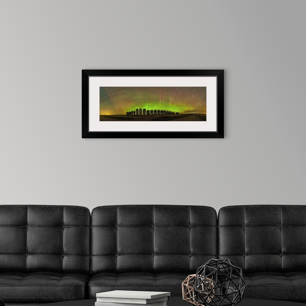 A modern room featuring A 180 degree panorama of a modest aurora display behind grain bins on a country road in Alberta, ...