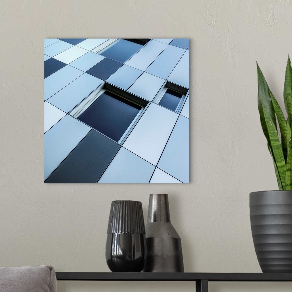 A modern room featuring Abstract photo of blue-toned windows and panels.