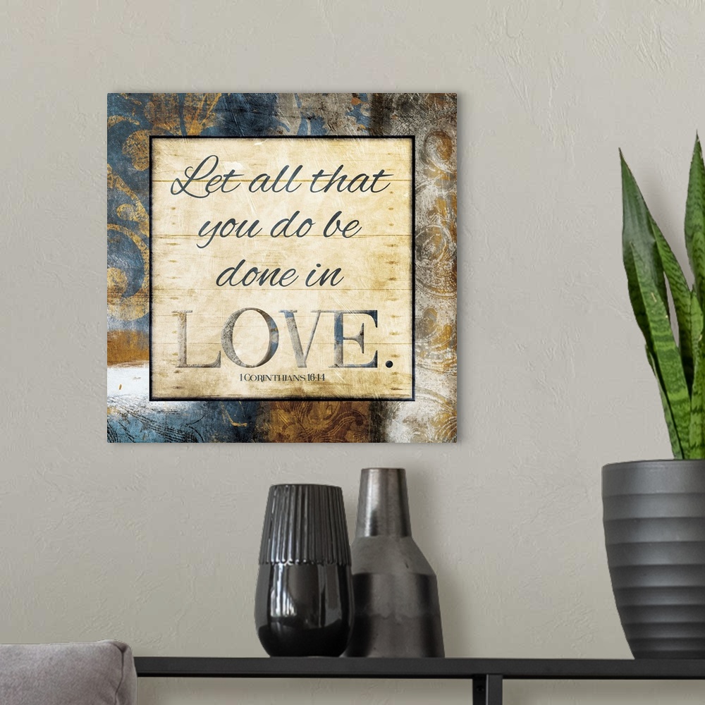 A modern room featuring Typography art of the Bible verse 1 Corinthians 16:14 framed with classic style gold and blue flo...