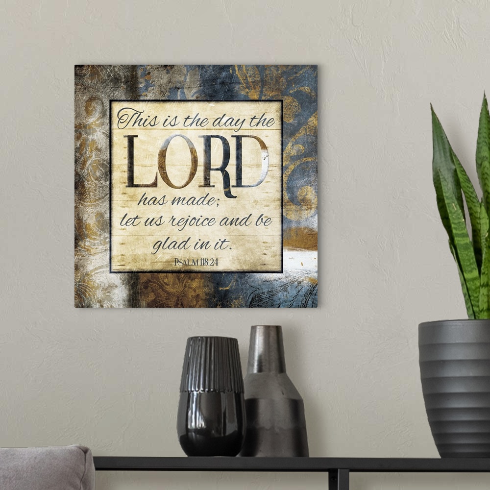 A modern room featuring Typography art of the Bible verse Psalm 118:24 framed with classic style gold and blue flourishes.