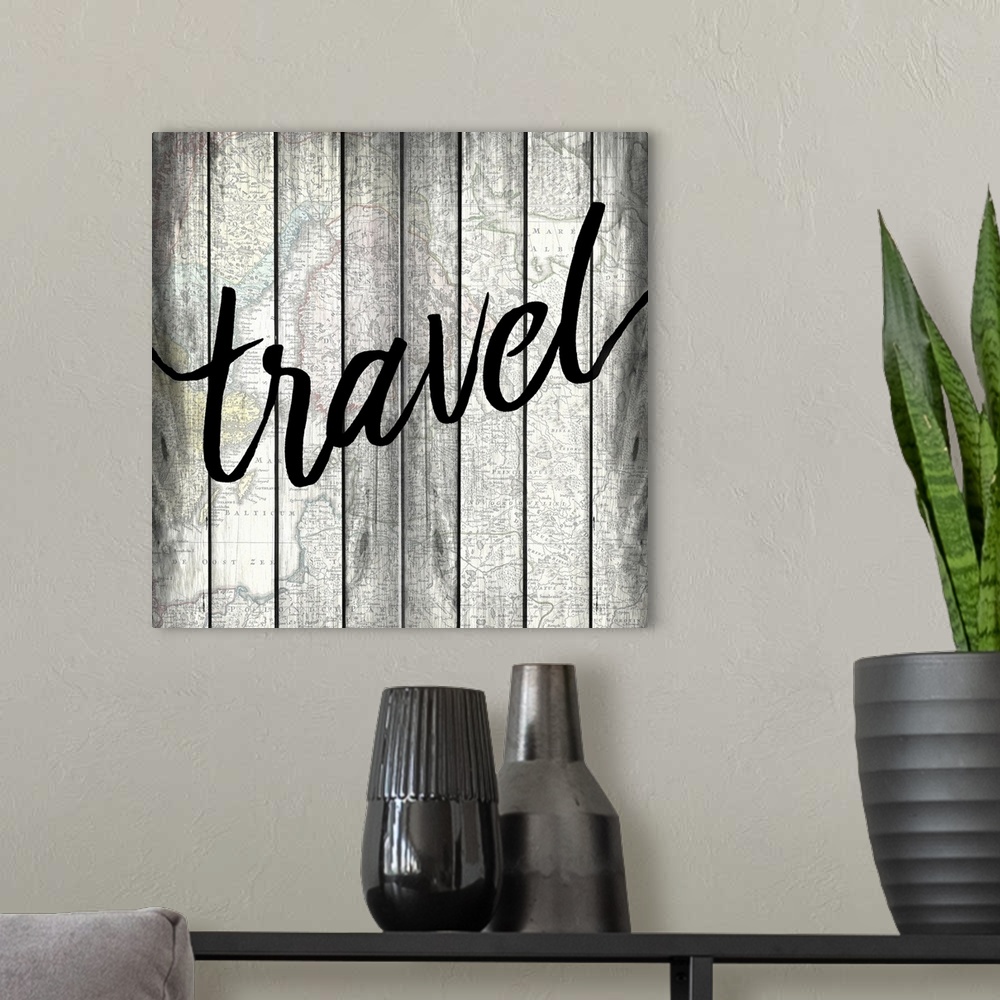A modern room featuring The word ?travel? painted on a wood panel background with an overlay of a map.�