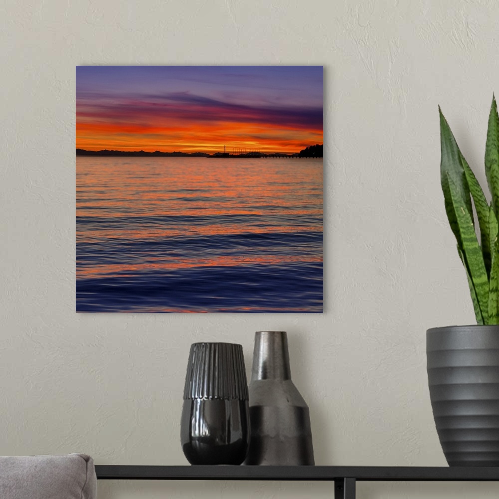 A modern room featuring Dramatic and vibrant sunset with a silhouetted coastline; Whiterock, British Columbia, Canada