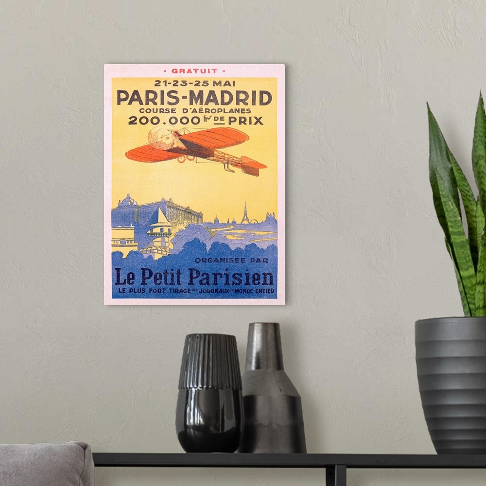 A modern room featuring Advertising artwork for an airplane race from France to Spain. The poster shows a propeller plane...