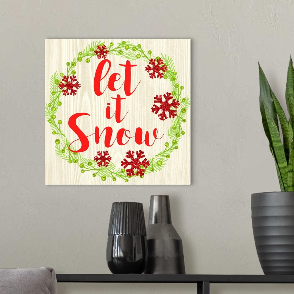 A modern room featuring "Let It Snow" written in red inside of a Christmas wreath on a faux wood background.