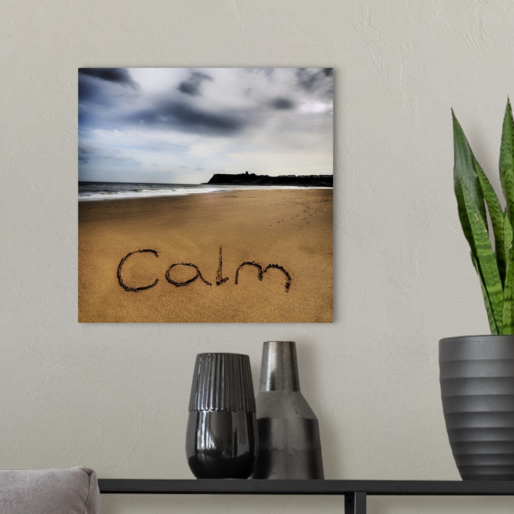 A modern room featuring Photo of the word written in the sand: Calm.