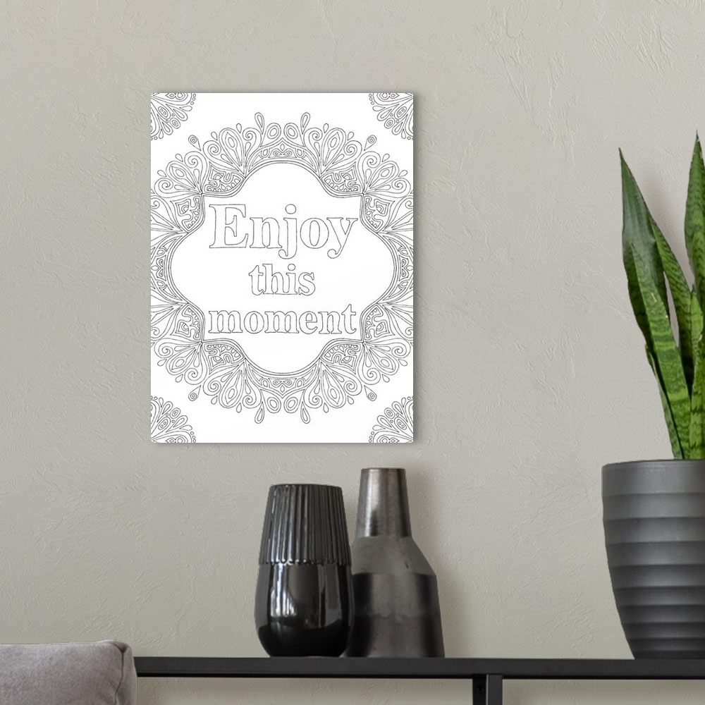 A modern room featuring Black and white line art with the phrase "Enjoy this moment" written in the center and curvy desi...