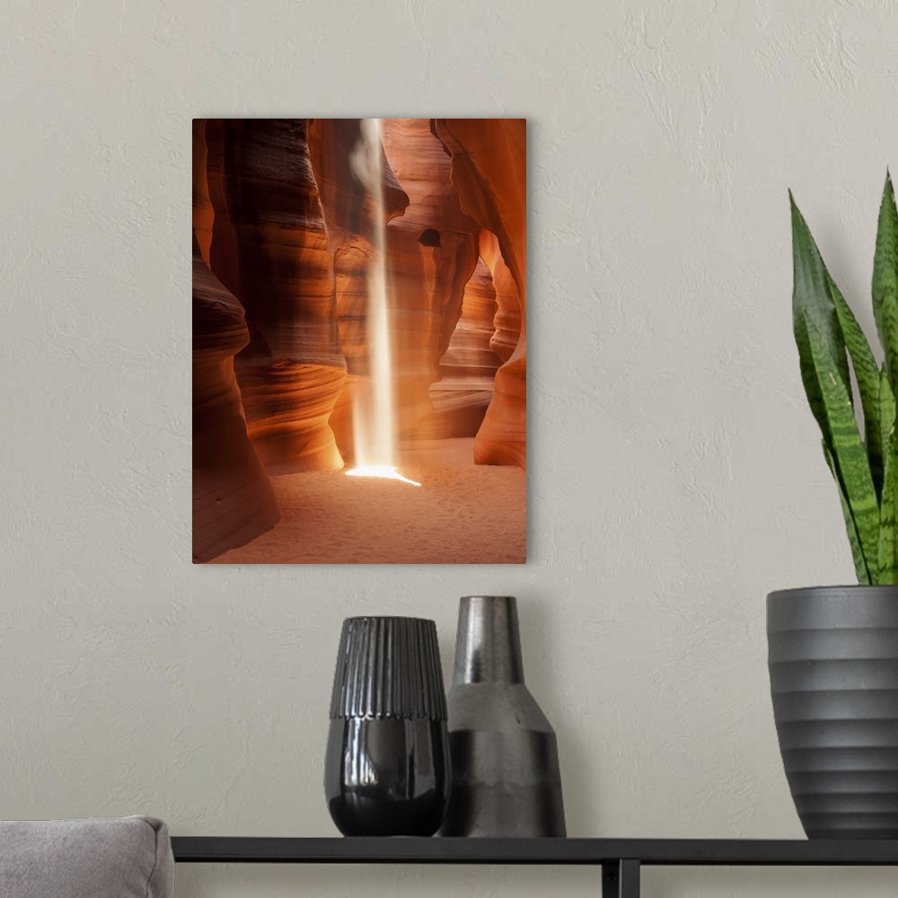 A modern room featuring An artistic photograph of a slot canyon with a shaft of sunlight piercing the crevasse above.
