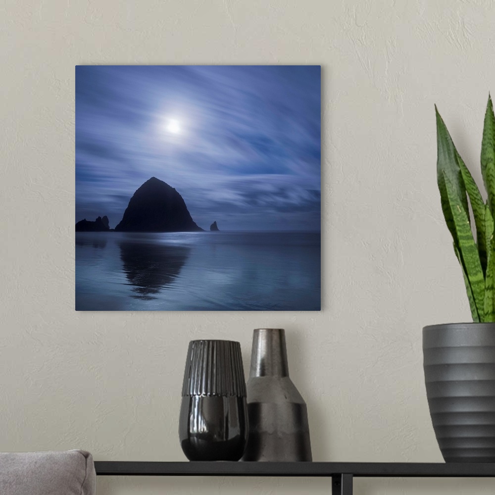 A modern room featuring An artistic photograph of a silhouetted Canon beach in Oregon.