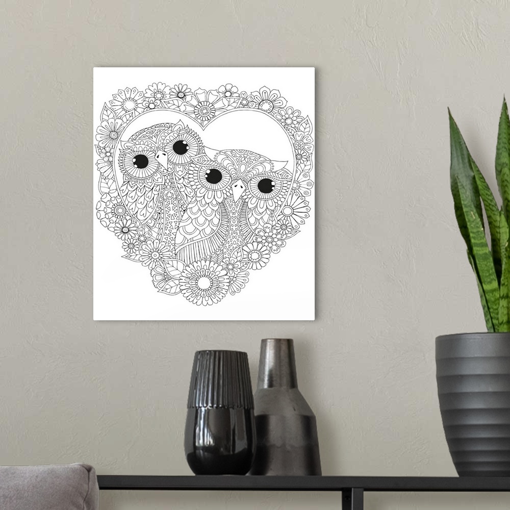 A modern room featuring Black and white line art of two owls inside a heart made out of flowers.