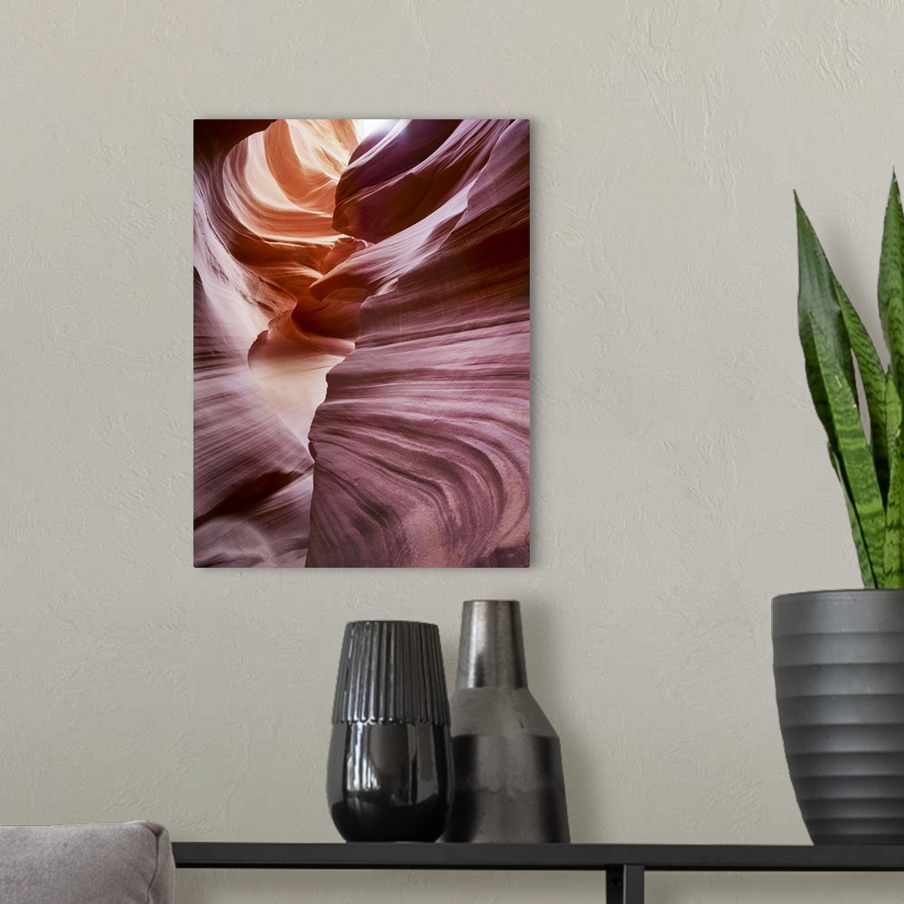 A modern room featuring An artistic photograph of reddish purple smooth layered rock formations.