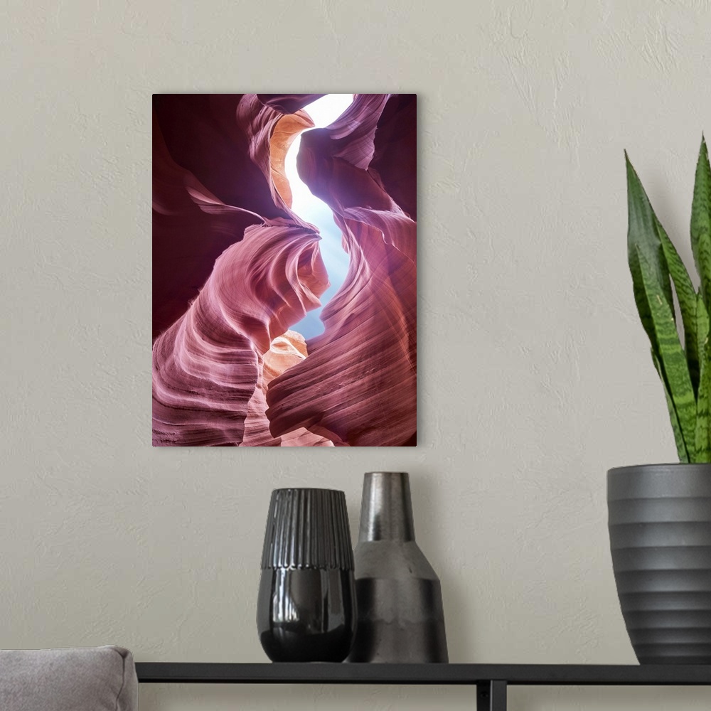 A modern room featuring An artistic photograph of reddish purple smooth layered rock formations.