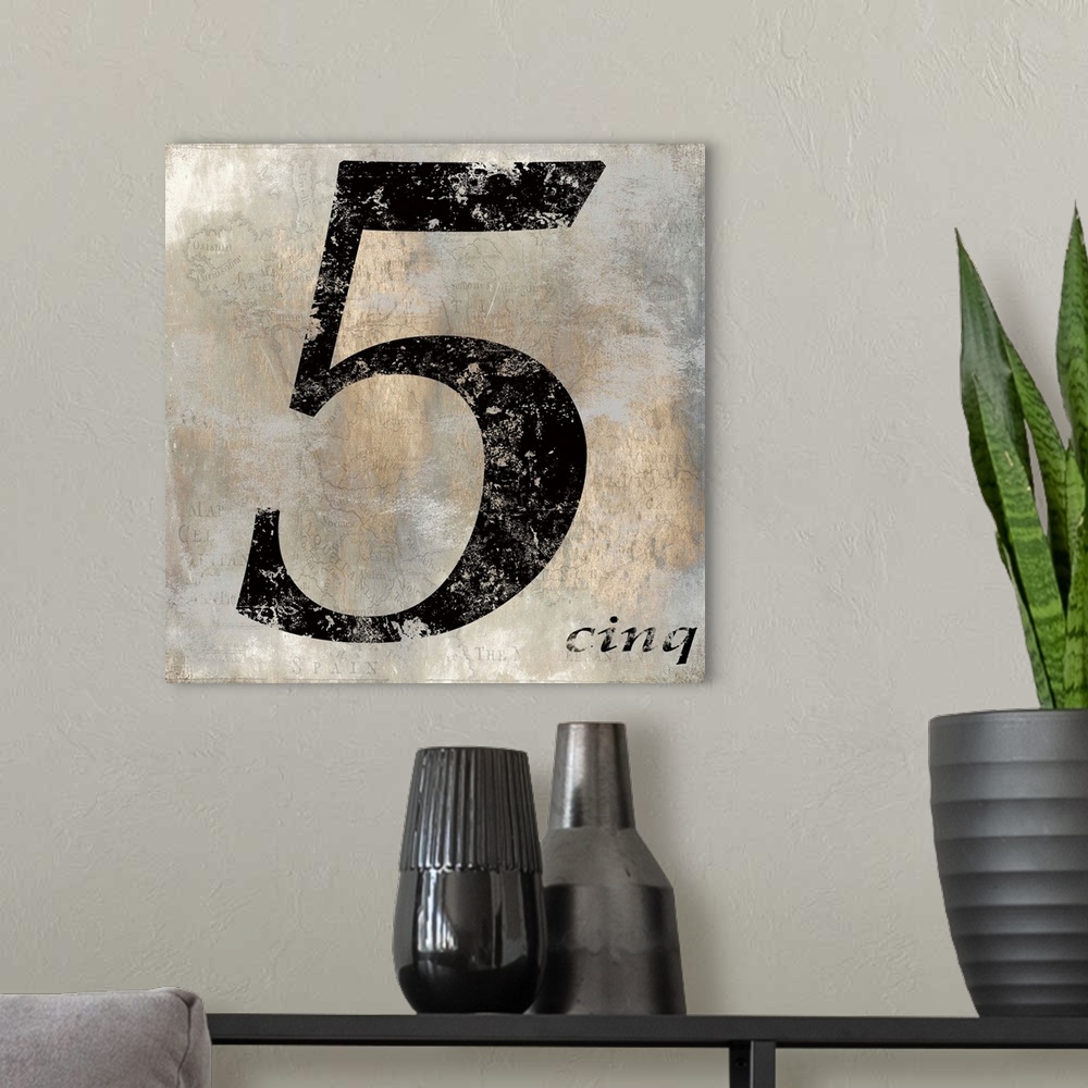 A modern room featuring French 5 sign in black, gold, and gray hues with a faint illustration of a map on the background.