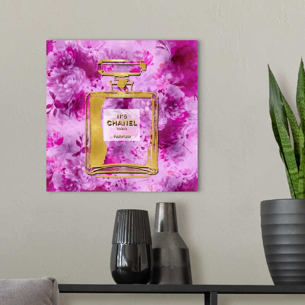 A modern room featuring A background of flowers peek through a transparent bottle of perfume.