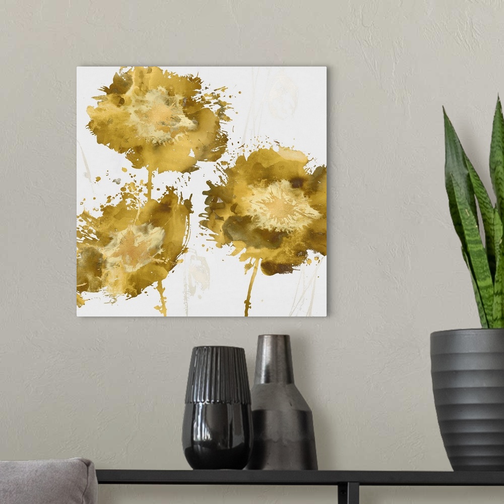 A modern room featuring Square decor with three paint splattered flowers in shades of gold.