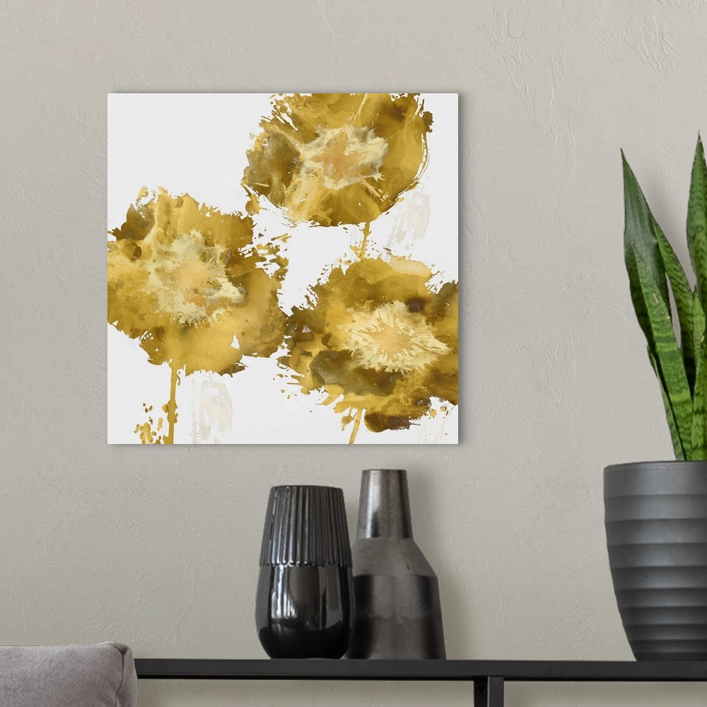 A modern room featuring Square decor with three paint splattered flowers in shades of gold.