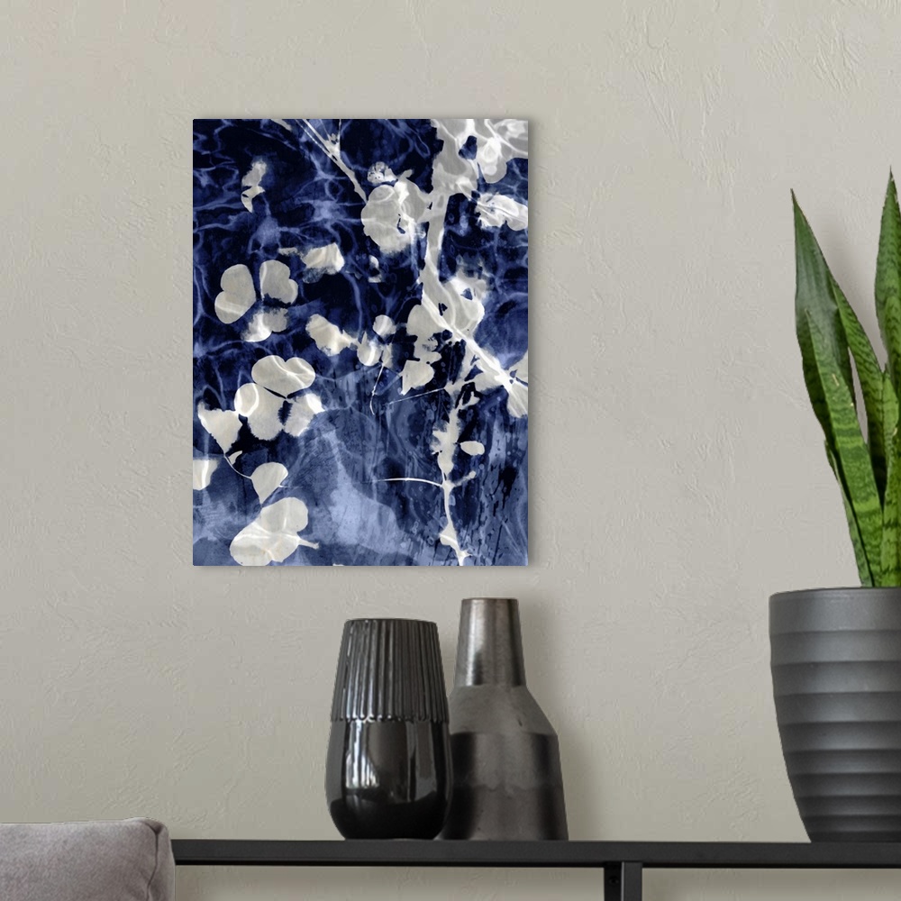 A modern room featuring Home decor with silver silhouettes of leaves and flowers on an indigo background with a watery look.