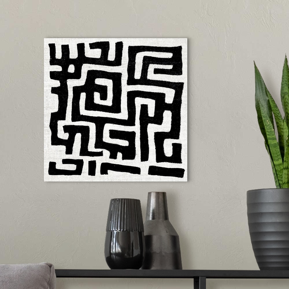 A modern room featuring Square abstract art created with black and white patterned lines.