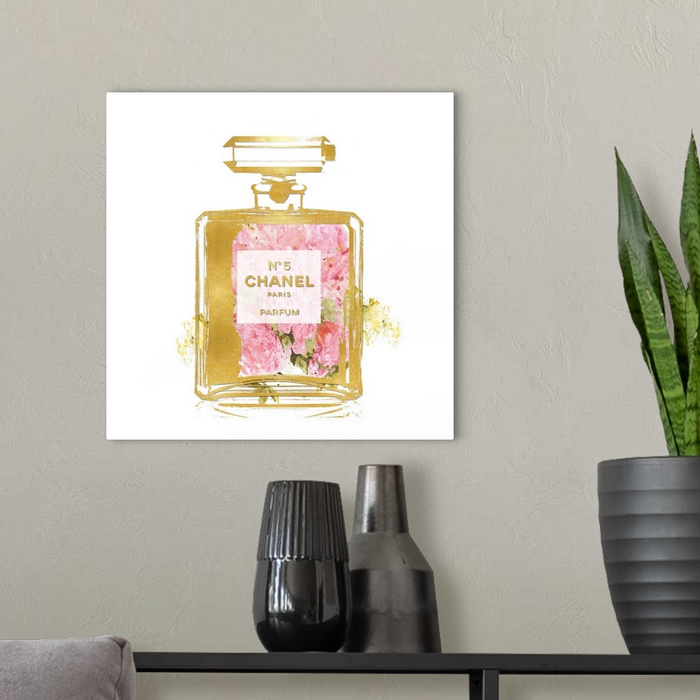 A modern room featuring Flowers peek through a transparent bottle of perfume.