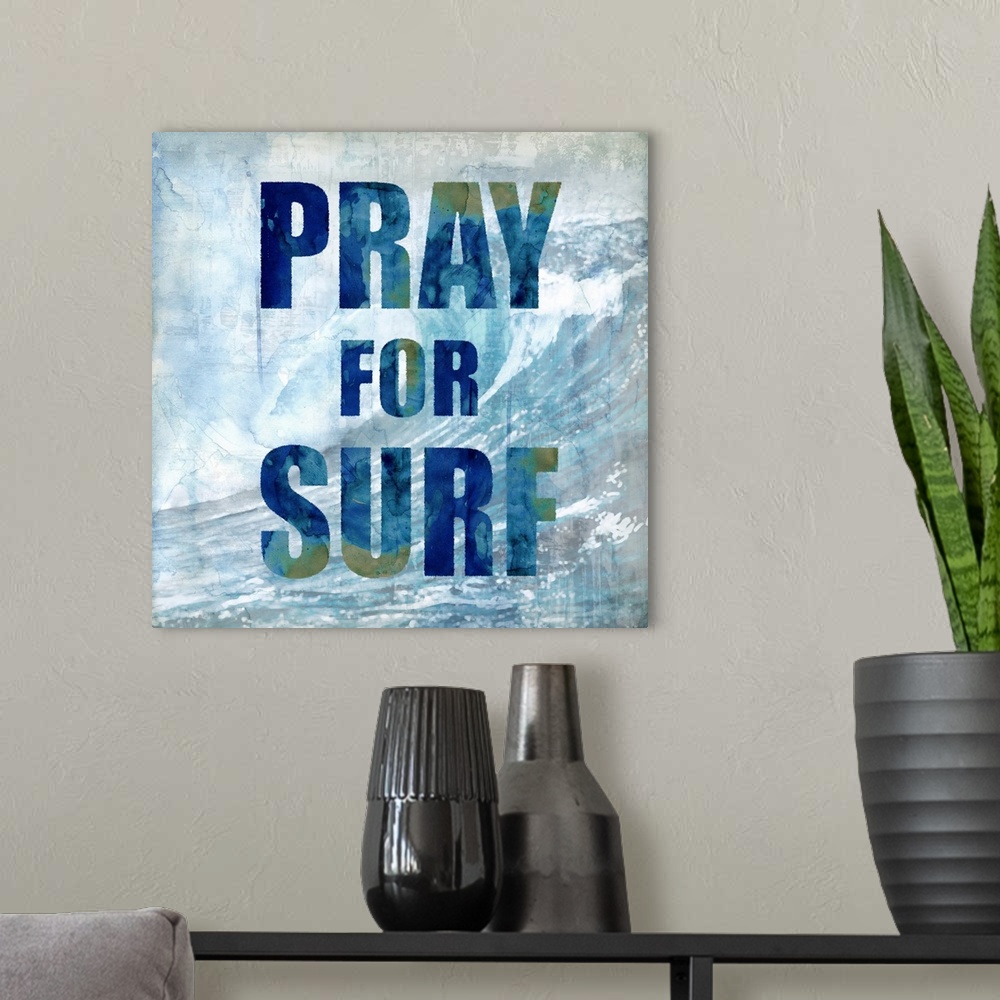 A modern room featuring Square beach themed decor with a large wave in the background and "Pray for Surf" written on top.