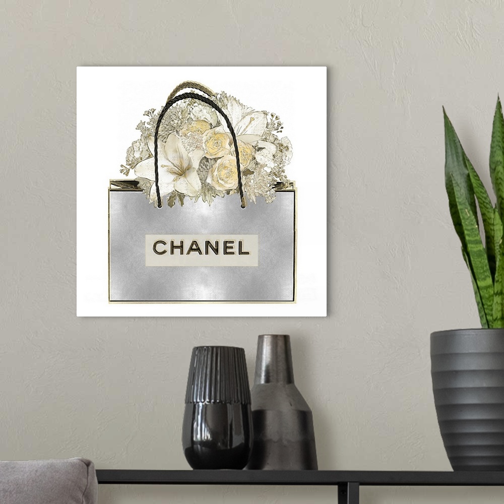 A modern room featuring A bouquet of flowers sits atop a shopping bag.