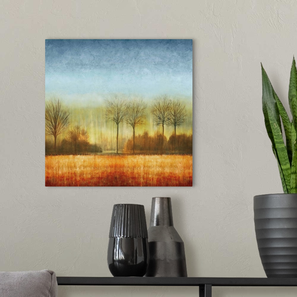 A modern room featuring Square decor with a winter landscape with bare trees and fading blue, green, yellow, orange, and ...