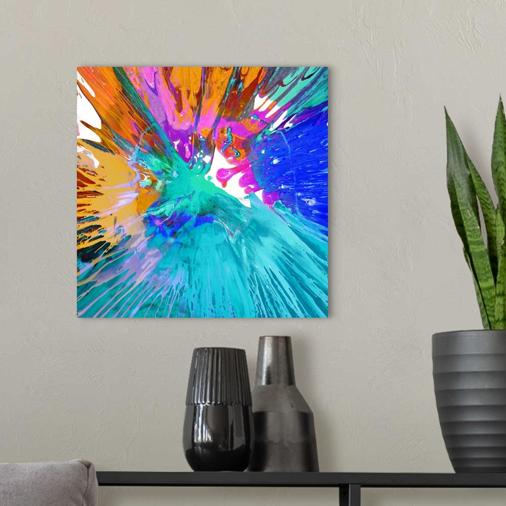 A modern room featuring Square abstract painting with a tie-dye effect in bright shades of blue, orange, red, and pink.