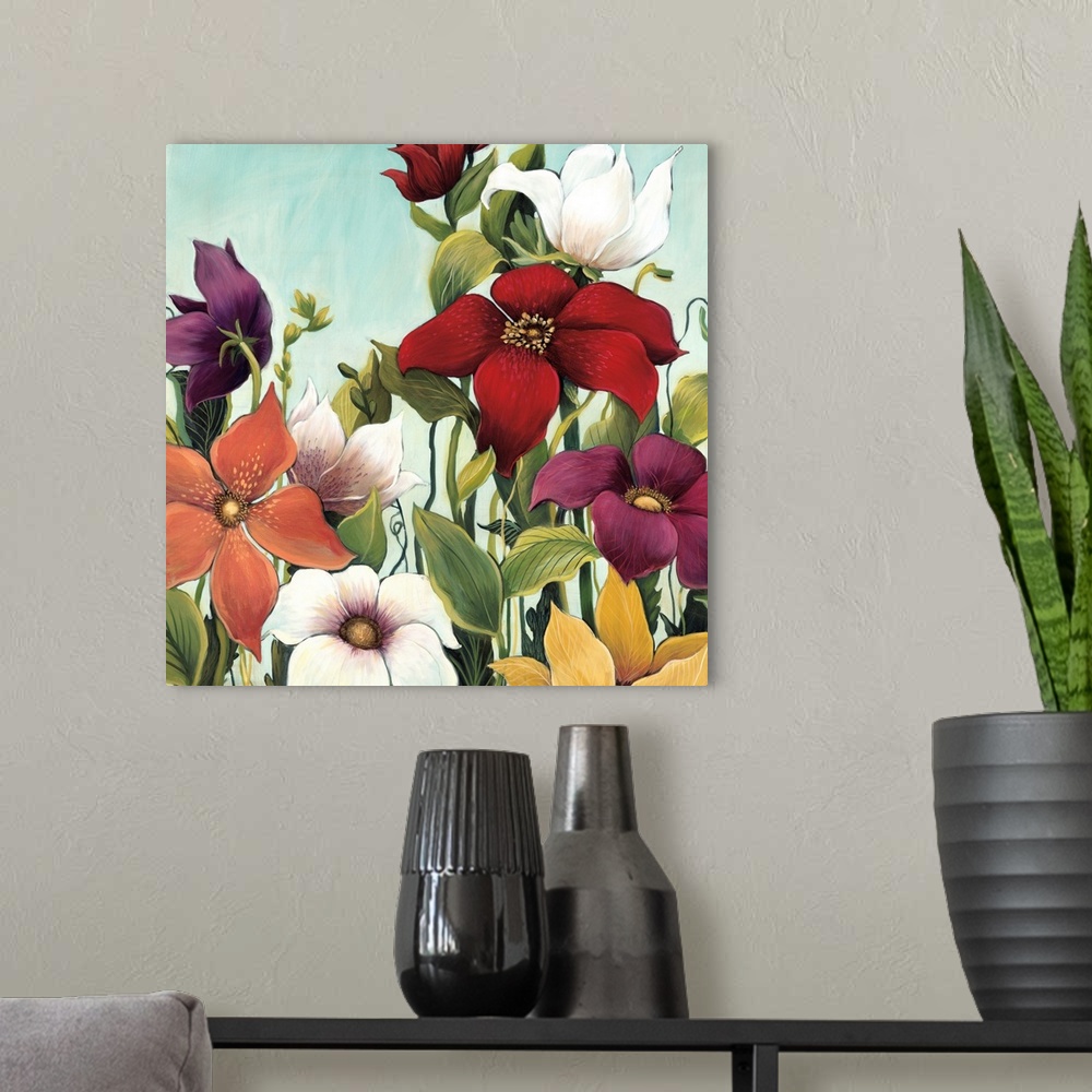 A modern room featuring Square painting of a group of multiple colored flowers in a garden against a blue backdrop.