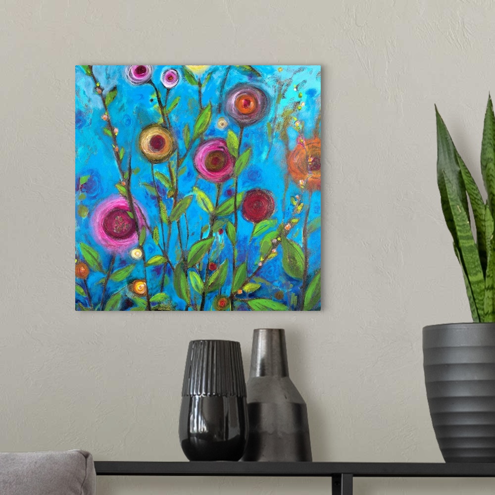A modern room featuring Square complementary painting of multi-colors of buttercup flowers upon a blue backdrop.