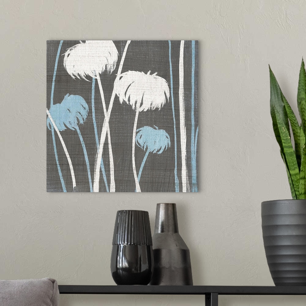 A modern room featuring Square contemporary artwork of blue and white flowers against a gray linen style backdrop.