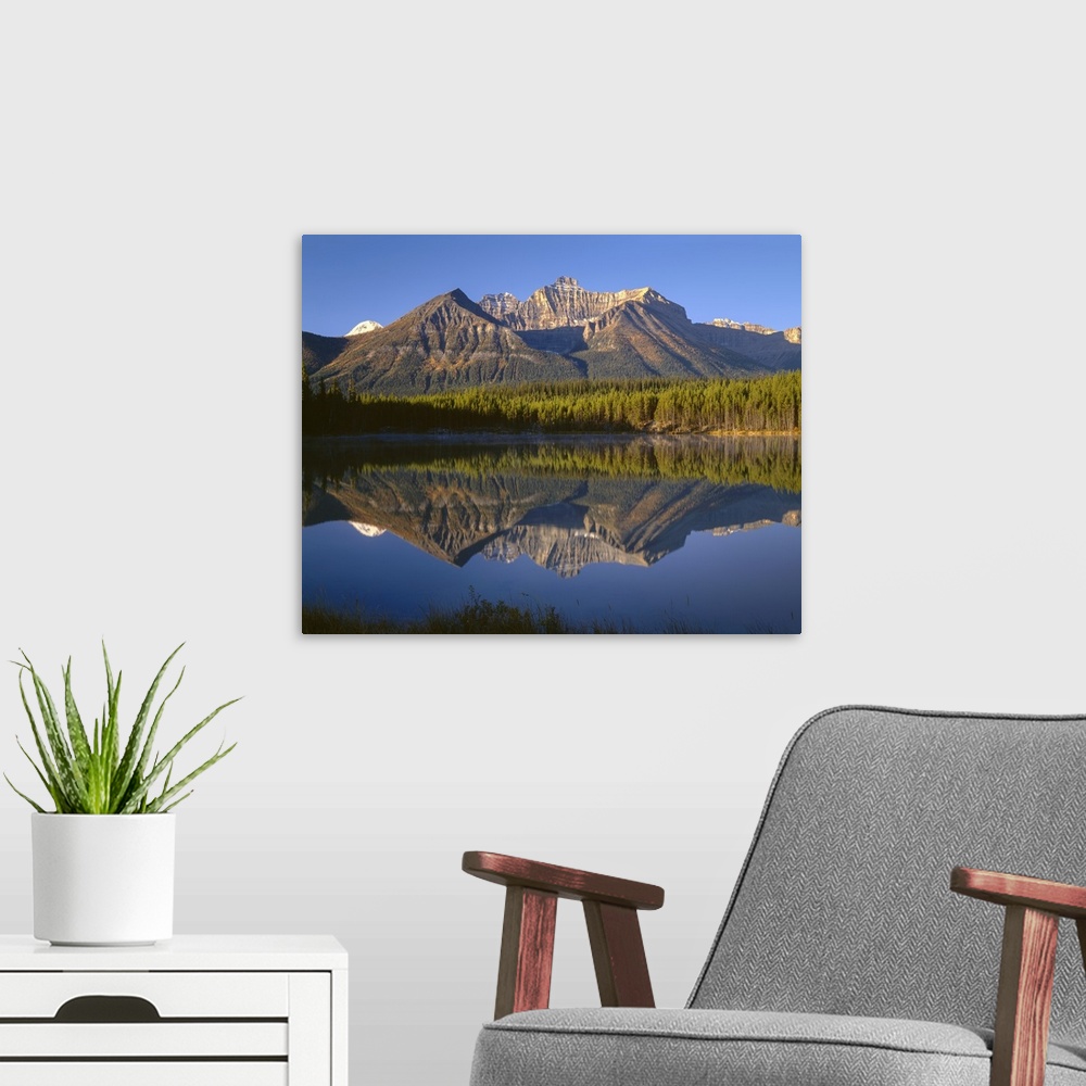 A modern room featuring Canada, Alberta, Banff National Park, Early morning light on the Bow Range reflects in Herbert La...