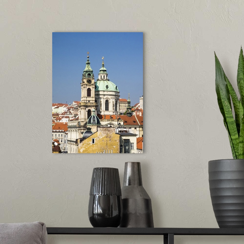 A modern room featuring Europe, Czech Republic, Prague. Prague rooftops and St. Nicholas Cathedral as seen from above.