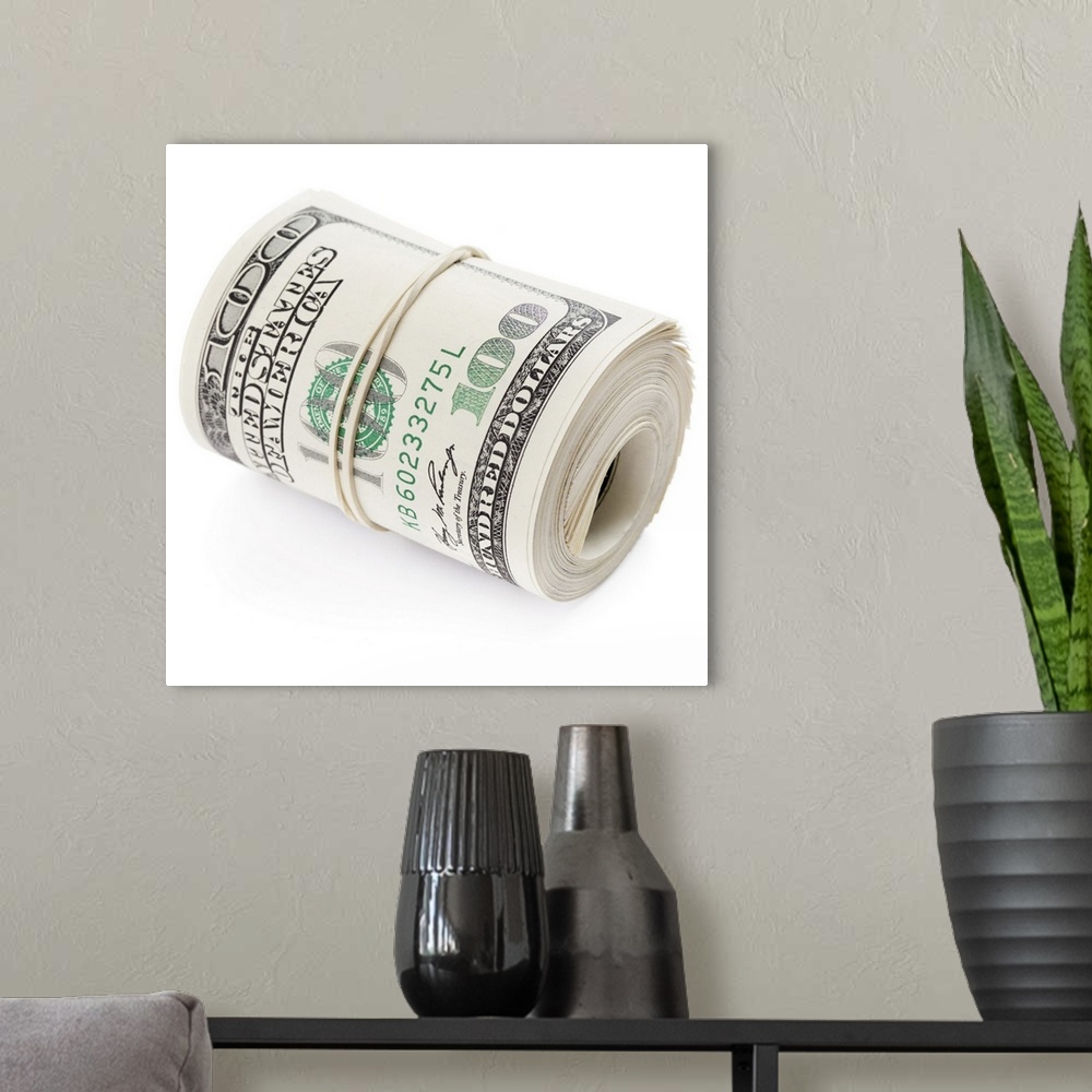 A modern room featuring Hundred dollar bills rolled up with rubber band.