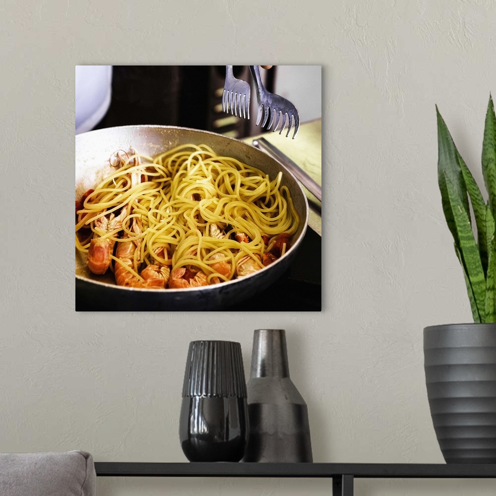 A modern room featuring Italy, Preparation of the traditional spaghetti alla busara (pasta with scampi)