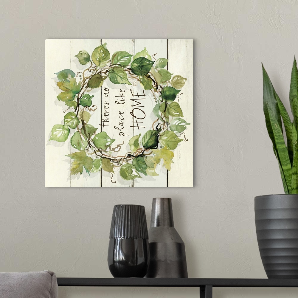 A modern room featuring A watercolor painting of a wreath with green leaves on a wood background and the phrase ?theres n...