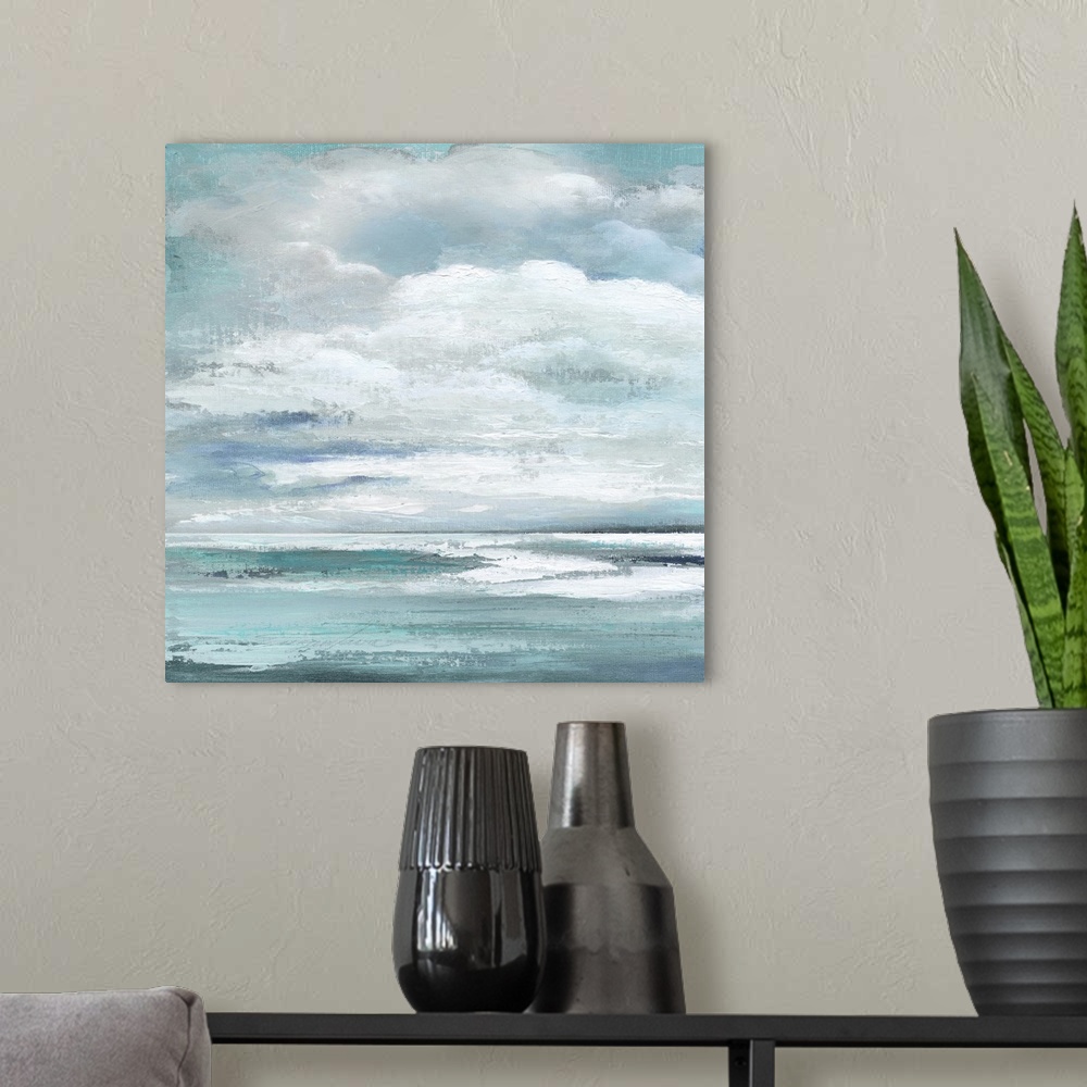 A modern room featuring A square contemporary painting of the ocean with large, puffy clouds above.
