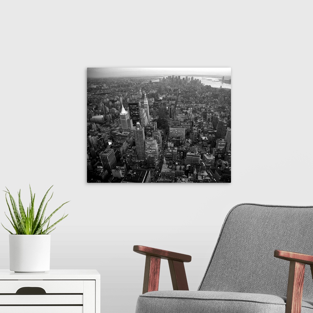 A modern room featuring An aerial black and white photograph of the city of New York.
