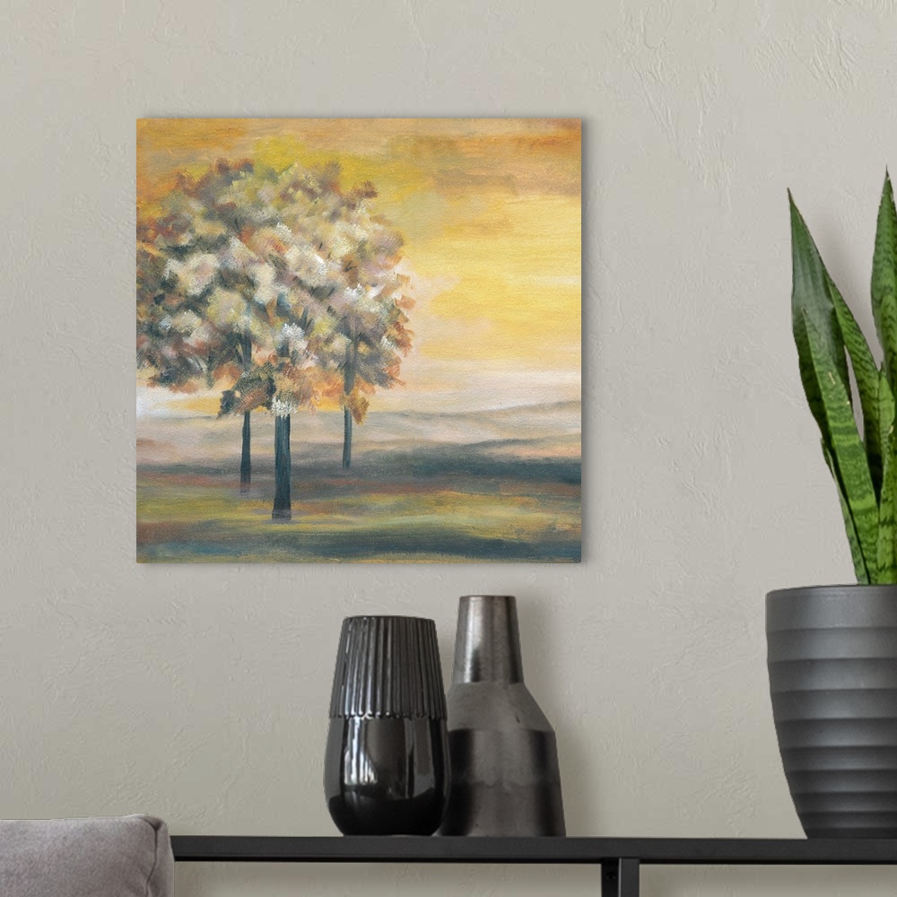 A modern room featuring Square painting of an Autumn sunset with three Autumn trees.