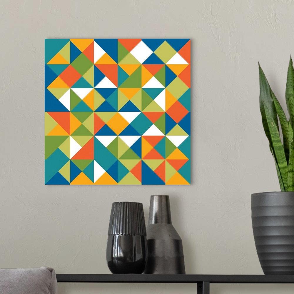 A modern room featuring Square geometric art with a triangular pattern in shades of blue, green, orange, yellow, and white.